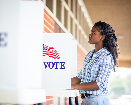 young woman standing at voting booth